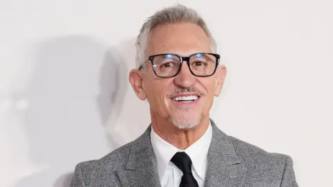 PA Media Gary Lineker in a suit and glasses, smiling at the GQ Men of the Year Awards last year