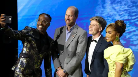 PA Billy Porter takes a selfie with the Prince of Wales, Robert Irwin and Nomzamo Mbatha.