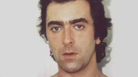 BBC John Cannan staring at the camera in a police mugshot