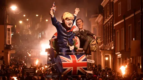 Reuters An effigy of former Prime Minister Boris Johnson holding a Union Jack flag and Jacob Rees-Mogg being paraded through Lewes High Street. 