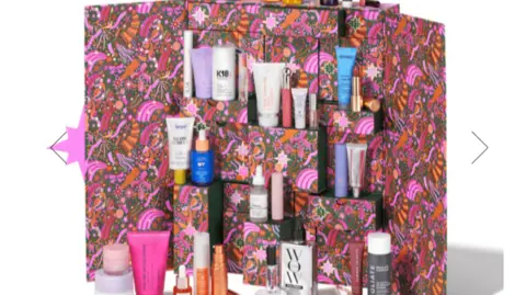 Space NK Space NK advent calendar showing a pink print box and various miniature beauty products