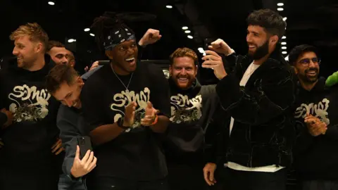 Anthony Stanley/WENN/Alamy The Sidemen standing in a row laughing, clapping and in celebratory poses, when opening a store in the Bullring Shopping Centre, Birmingham, in October 2024